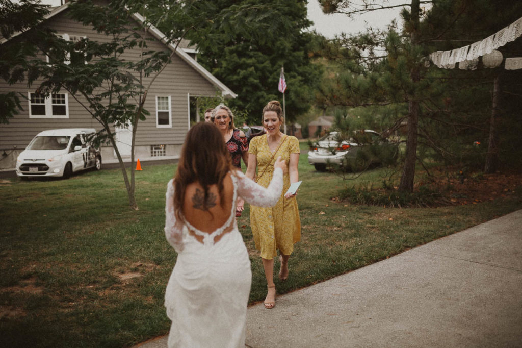 wedding guests arriving to backyard wedding